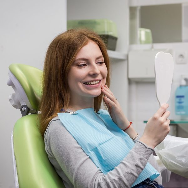 Dentist examining girl’s teeth in clinic. Dental problem. Healthy Smile. Dentist examining girl's teeth in clinic. Dental problem. Healthy Smile.